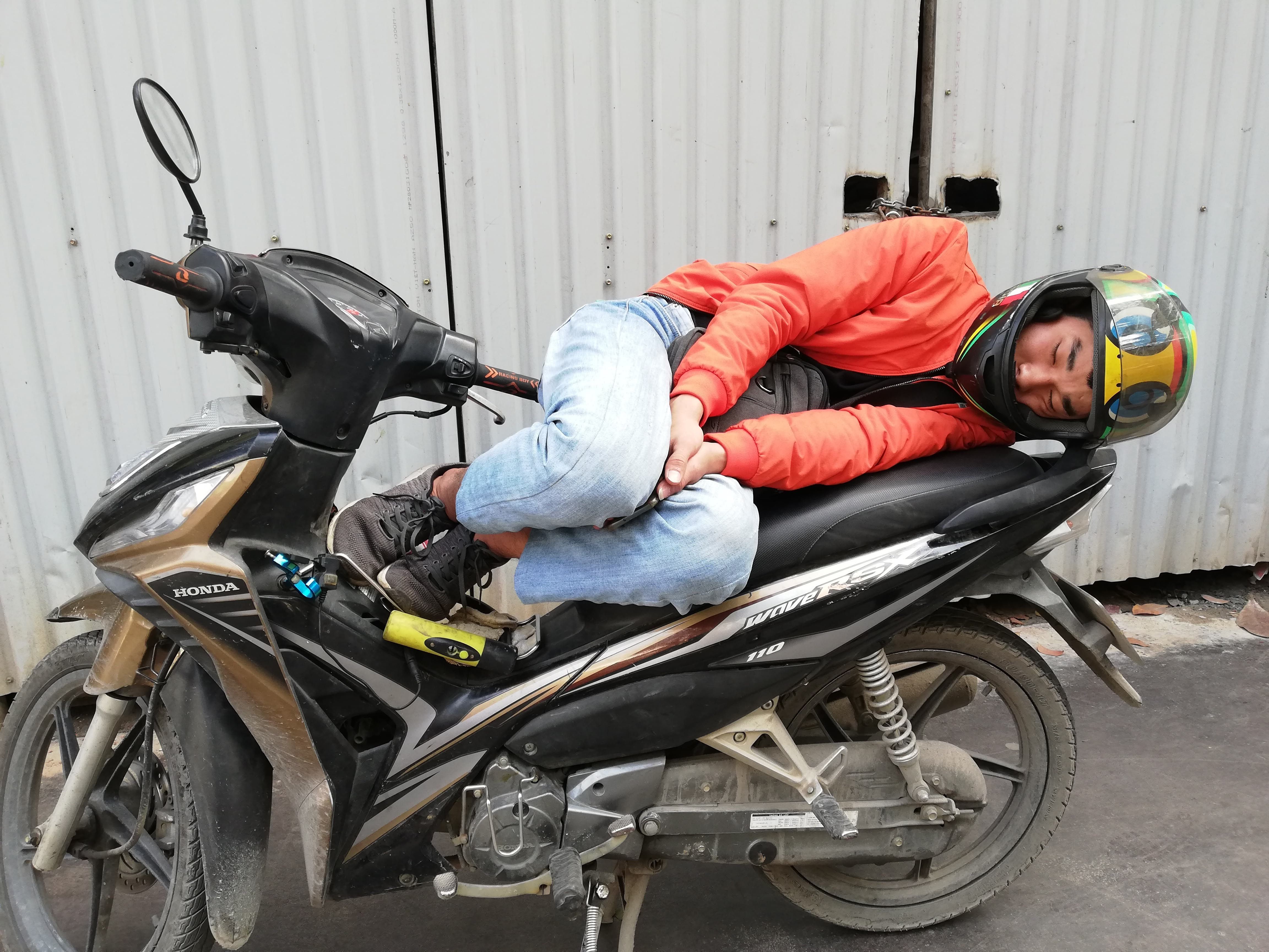 Woman sleeping on her motorcycle